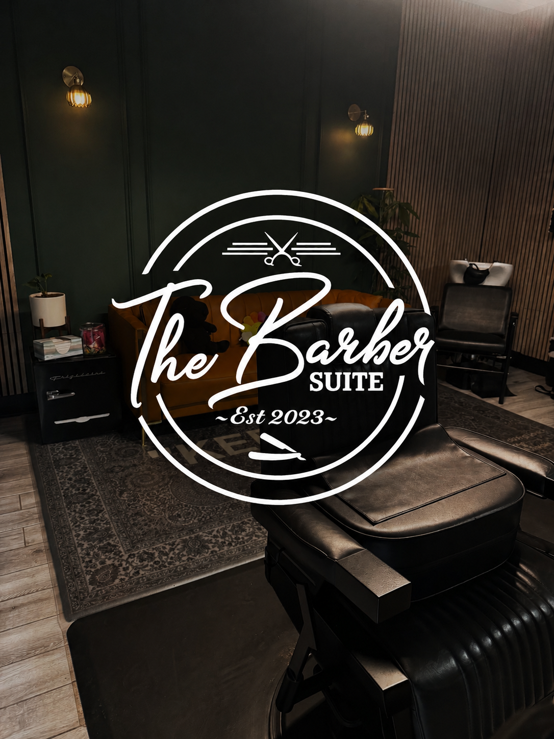 Interior of The Barber Suite with the studio logo, a private premium men's grooming studio